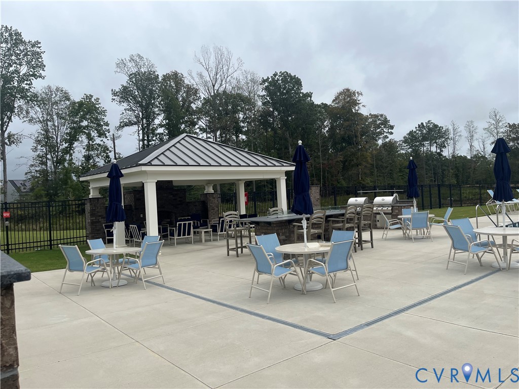 7430 East Danube Loop New Kent, VA 23124 - Photo 26 of 27 Patio with grilling & dining area around the pool.