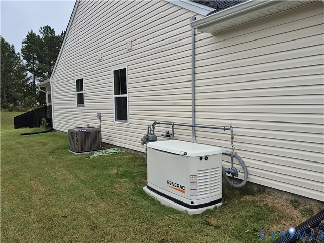 a view of a white house with a yard and furniture