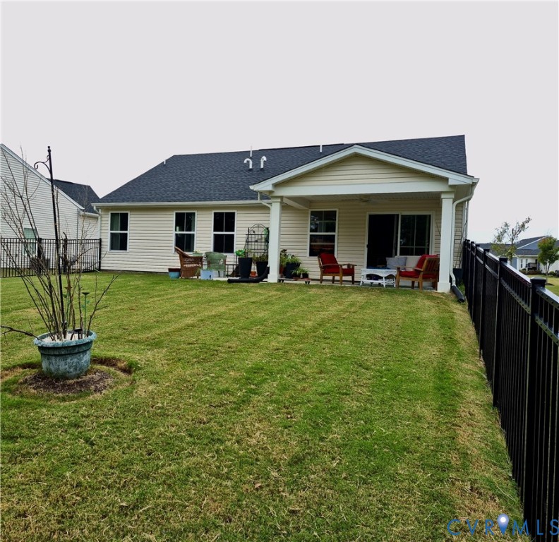 7430 East Danube Loop New Kent, VA 23124 - Photo 5 of 27 a front view of a house with a yard