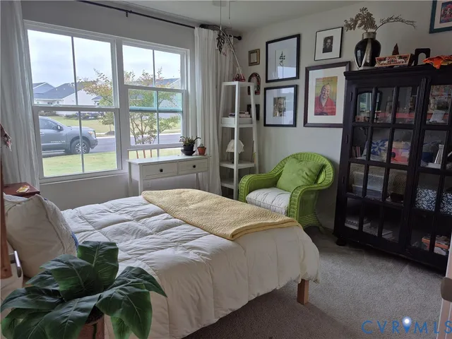 a bedroom with a bed furniture and a large window
