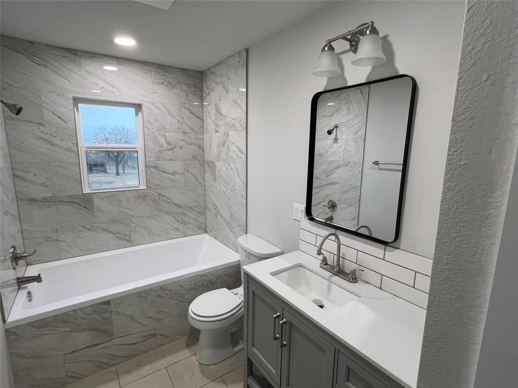 526 Jack Grace Hill Road Bowie, TX 76230 - Photo 15 of 34 a bathroom with a sink a toilet and bathtub