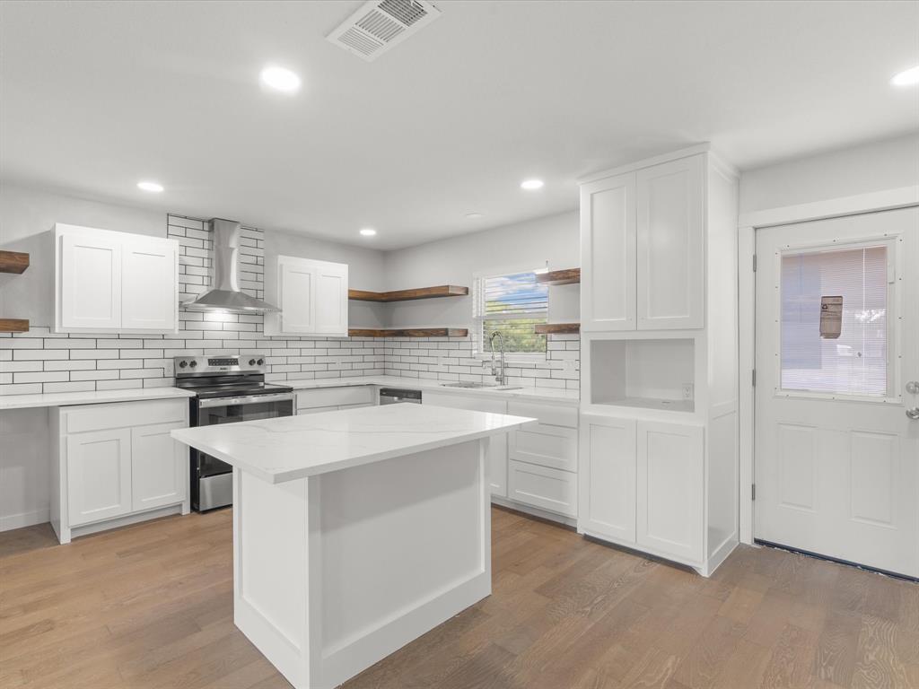 526 Jack Grace Hill Road Bowie, TX 76230 - Photo 20 of 34 a kitchen with white cabinets appliances and sink