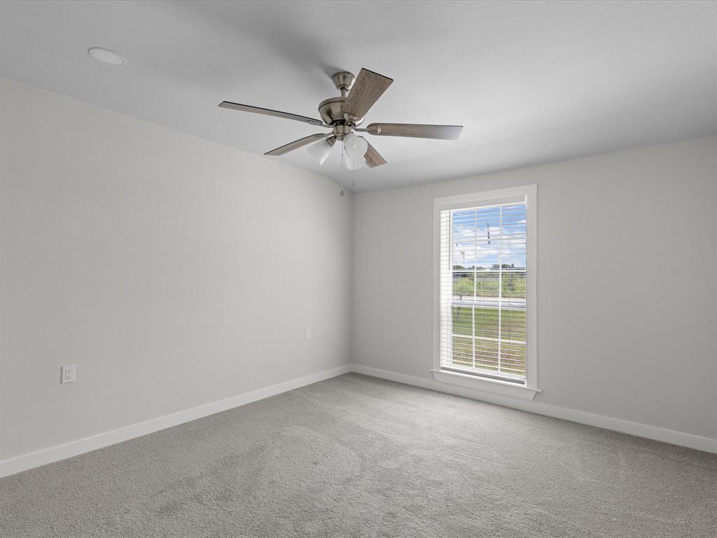 526 Jack Grace Hill Road Bowie, TX 76230 - Photo 24 of 34 an empty room with windows and fan