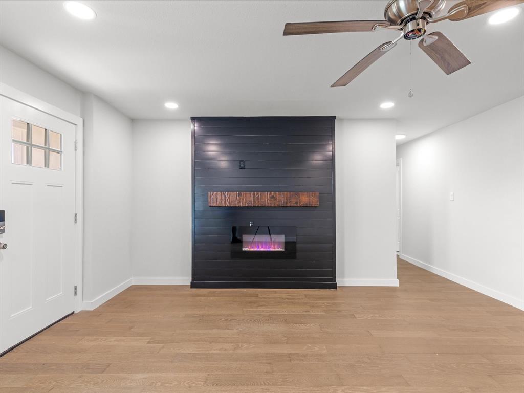 526 Jack Grace Hill Road Bowie, TX 76230 - Photo 27 of 34 a view of an empty room with a fireplace and a fan