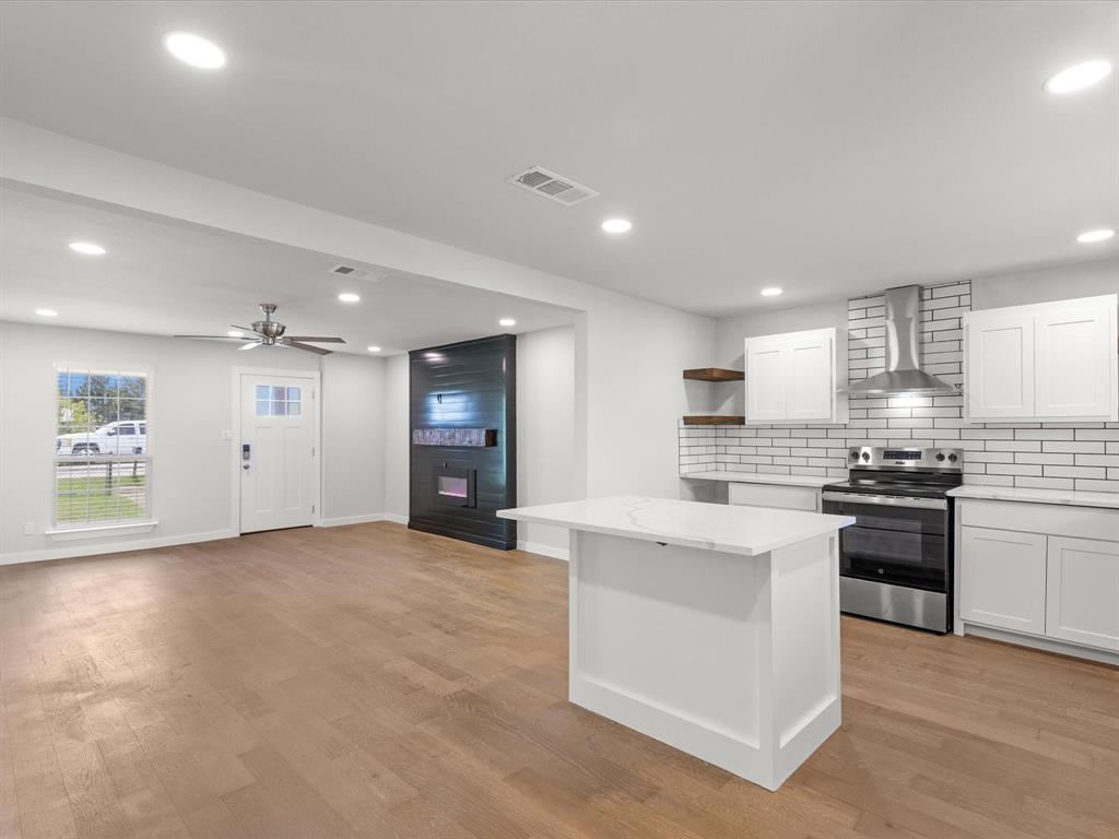 526 Jack Grace Hill Road Bowie, TX 76230 - Photo 4 of 34 a large kitchen with stainless steel appliances granite countertop a stove top oven a sink and dishwasher