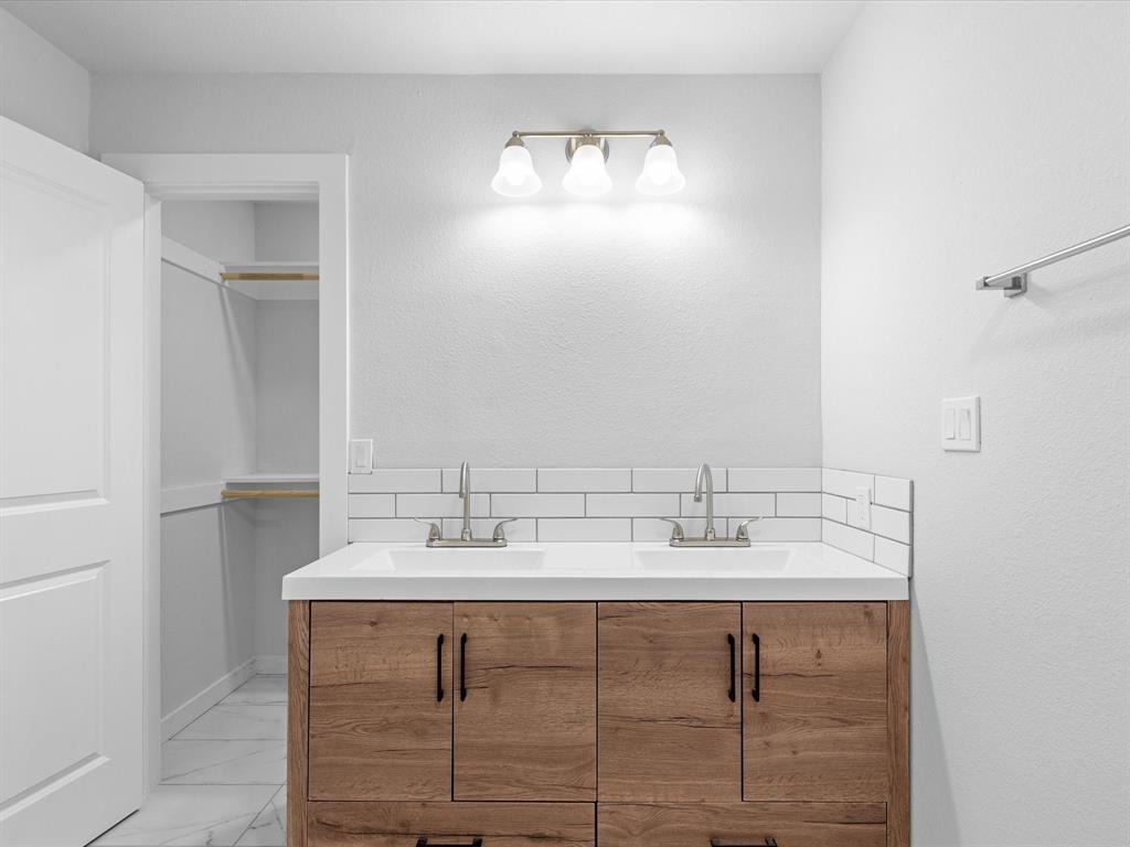 526 Jack Grace Hill Road Bowie, TX 76230 - Photo 5 of 34 a bathroom with a sink double vanity and a mirror
