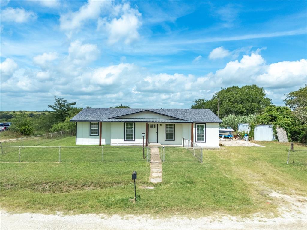 526 Jack Grace Hill Road Bowie, TX 76230 - Photo 9 of 34 a front view of a house with garden