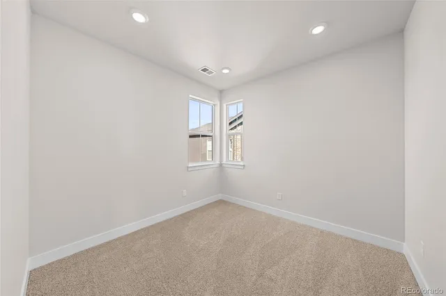 an empty room with a empty space and windows