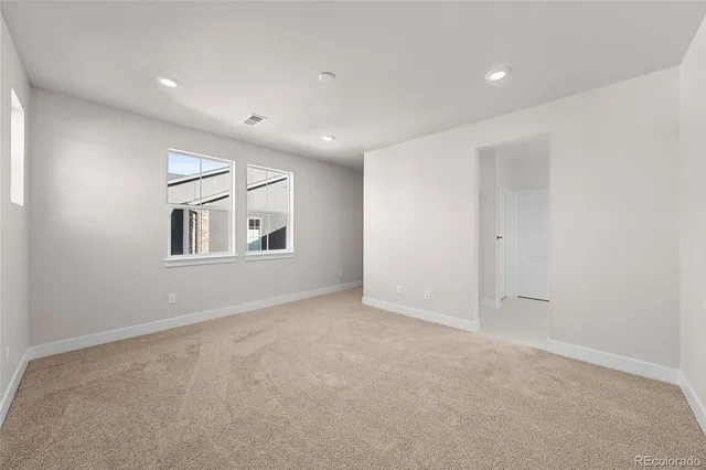 a spacious bathroom with a double vanity sink a large mirror a shower and