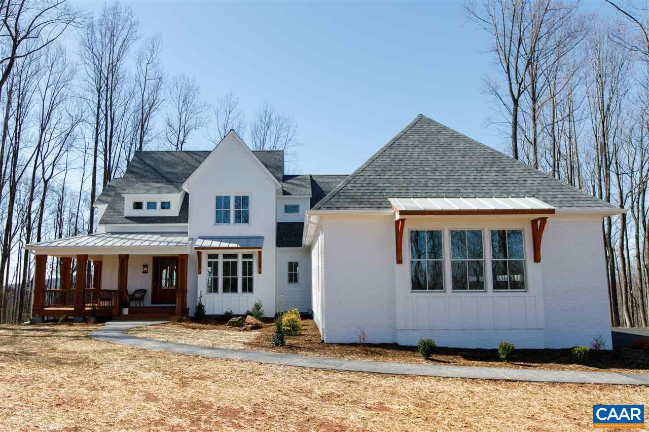 2412 Summit Ridge Trail Charlottesville, VA 22911 - Photo 1 of 41 a view of a white house with large windows next to a road