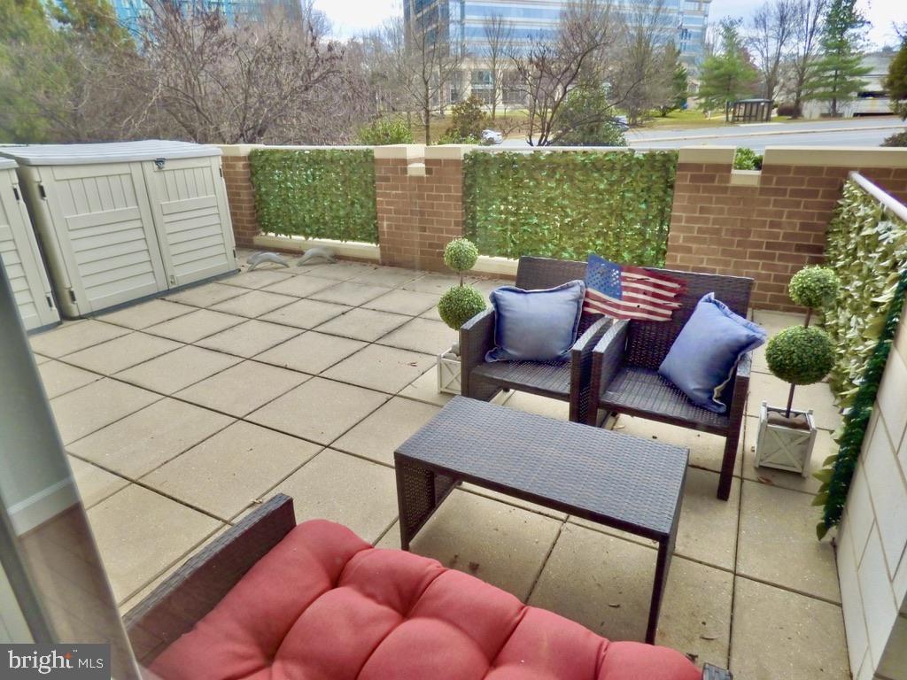 11800 Sunset Hills Road, Unit 118 Reston, VA 20190 - Photo 29 of 52 Charming patio retreat with greenery.