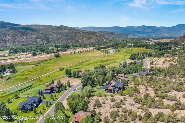 a view of a town with mountains in the background