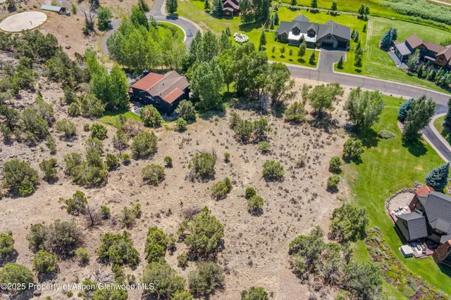 a view of swimming pool with seating area and small garden