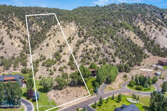 a view of a mountain with a yard