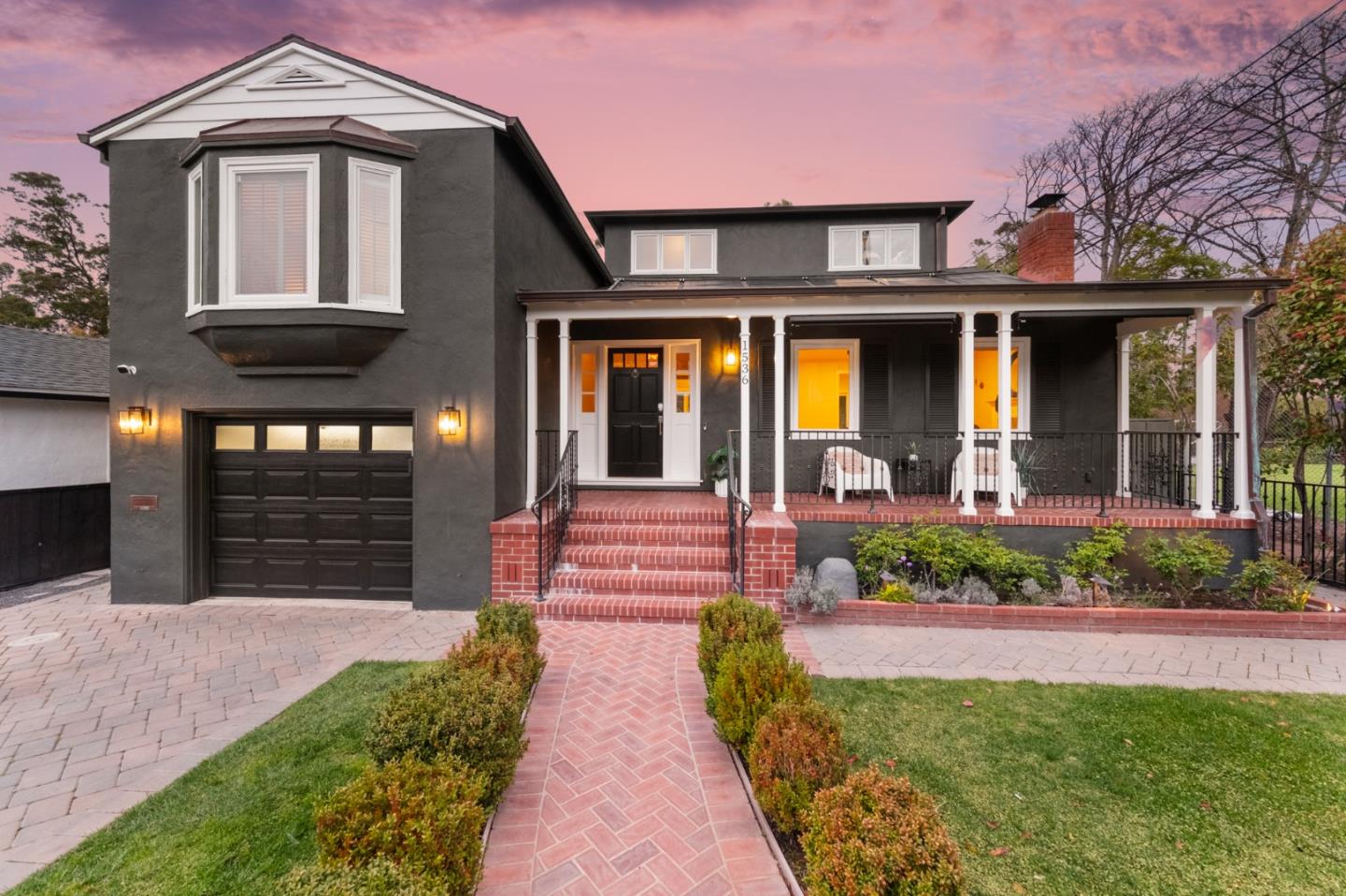 a front view of a house with garden