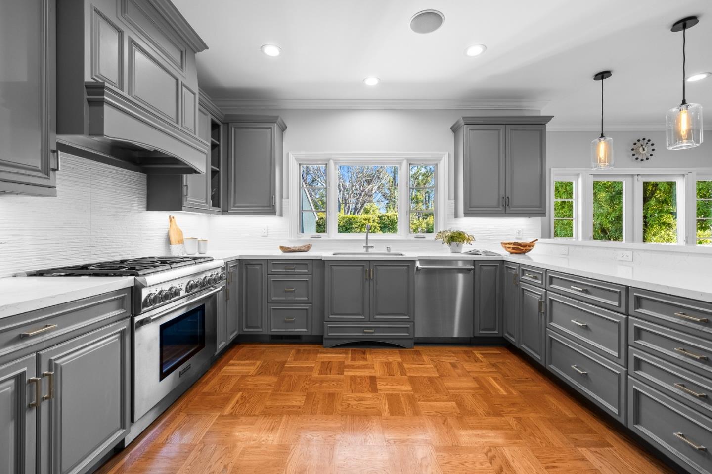 1536 Eastmoor Road Burlingame, CA 94010 - Photo 16 of 70 a kitchen with stainless steel appliances granite countertop a stove a sink dishwasher and white cabinets with wooden floor