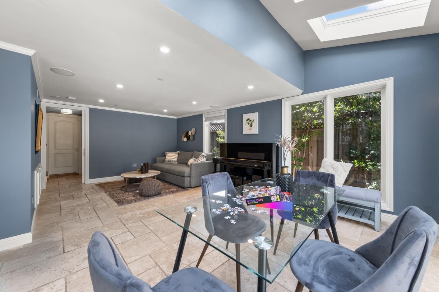 1536 Eastmoor Road Burlingame, CA 94010 - Photo 26 of 70 a living room with furniture a fireplace and a large window