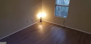 an empty room with wooden floor and closet