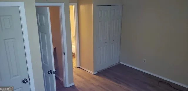 a view of a hallway with wooden floor