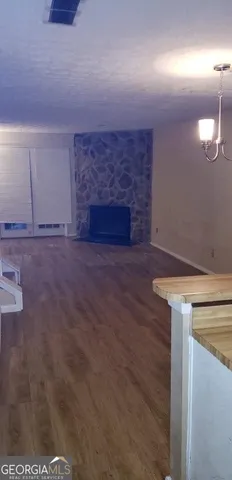 a view of a livingroom with an empty space and a fireplace