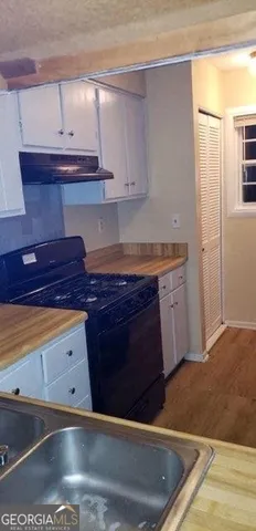 a kitchen with a sink and cabinets