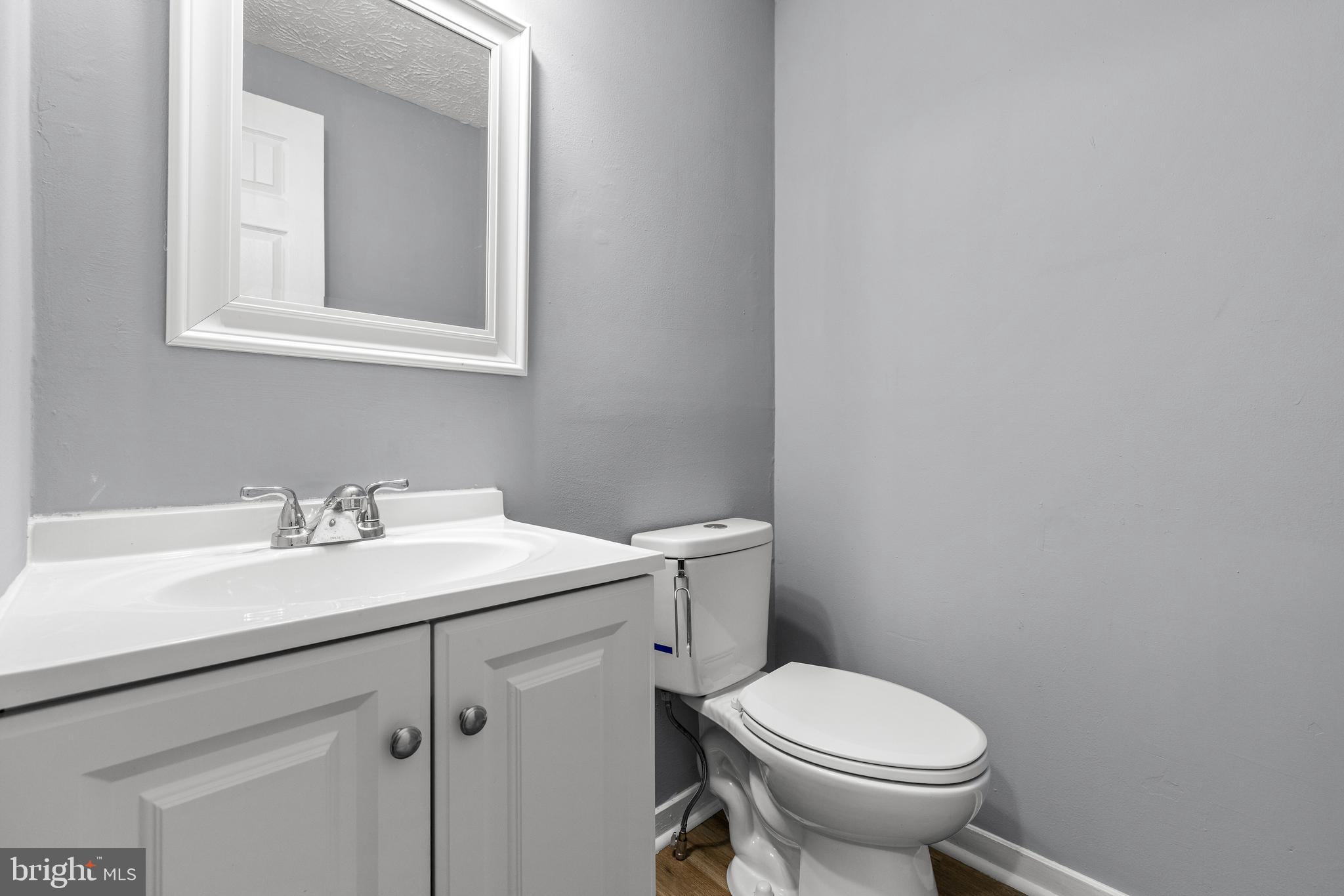 9479 Inaugural Drive King George, VA 22485 - Photo 10 of 26 a bathroom with a granite countertop toilet sink and mirror