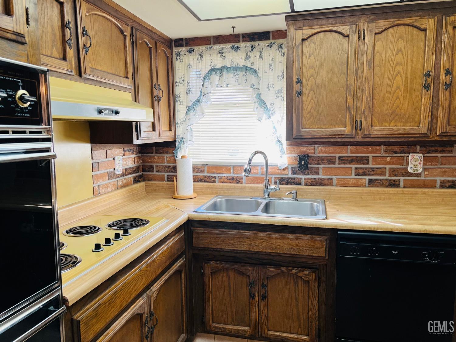Undisclosed Address Bakersfield, CA 93305 - Photo 11 of 22 a kitchen with a sink cabinets and stainless steel appliances