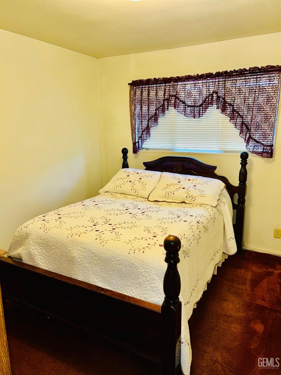 Undisclosed Address Bakersfield, CA 93305 - Photo 14 of 22 a bed sitting in a bedroom next to a wall