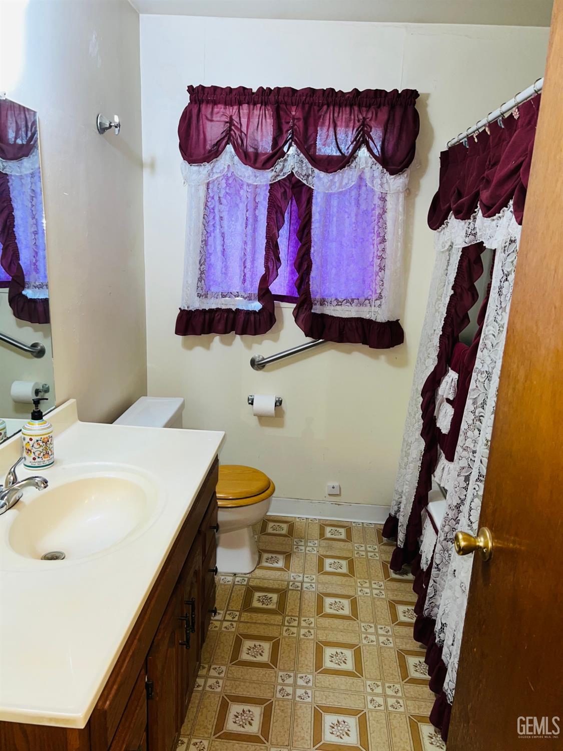 Undisclosed Address Bakersfield, CA 93305 - Photo 17 of 22 a bathroom with a sink and a mirror