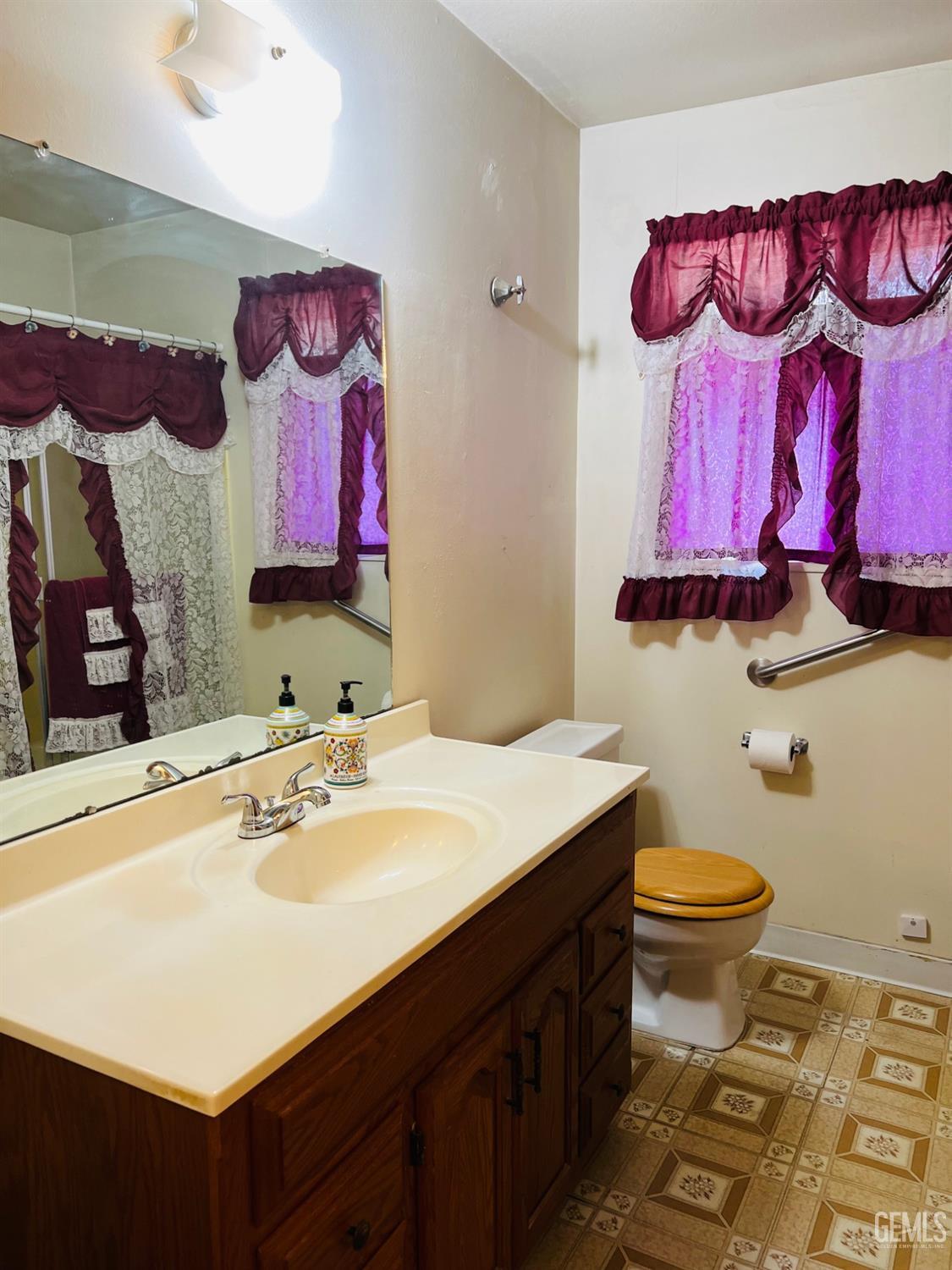 Undisclosed Address Bakersfield, CA 93305 - Photo 18 of 22 a bathroom with a sink and a mirror