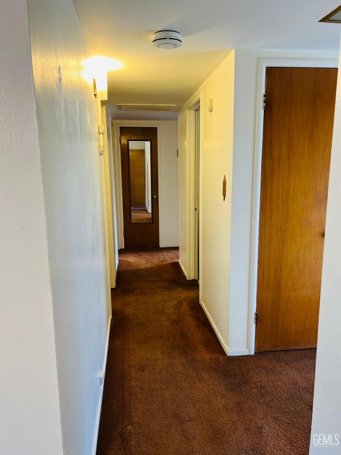 Undisclosed Address Bakersfield, CA 93305 - Photo 19 of 22 a view of a hallway with wooden floor