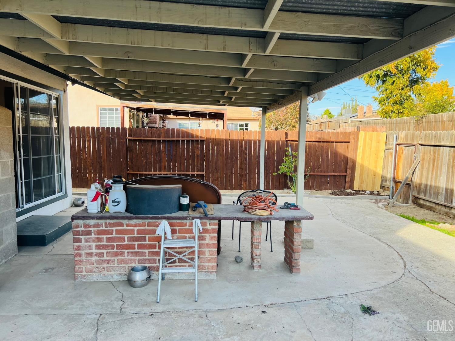 Undisclosed Address Bakersfield, CA 93305 - Photo 21 of 22 a view of a chairs and table in the back yard of the house