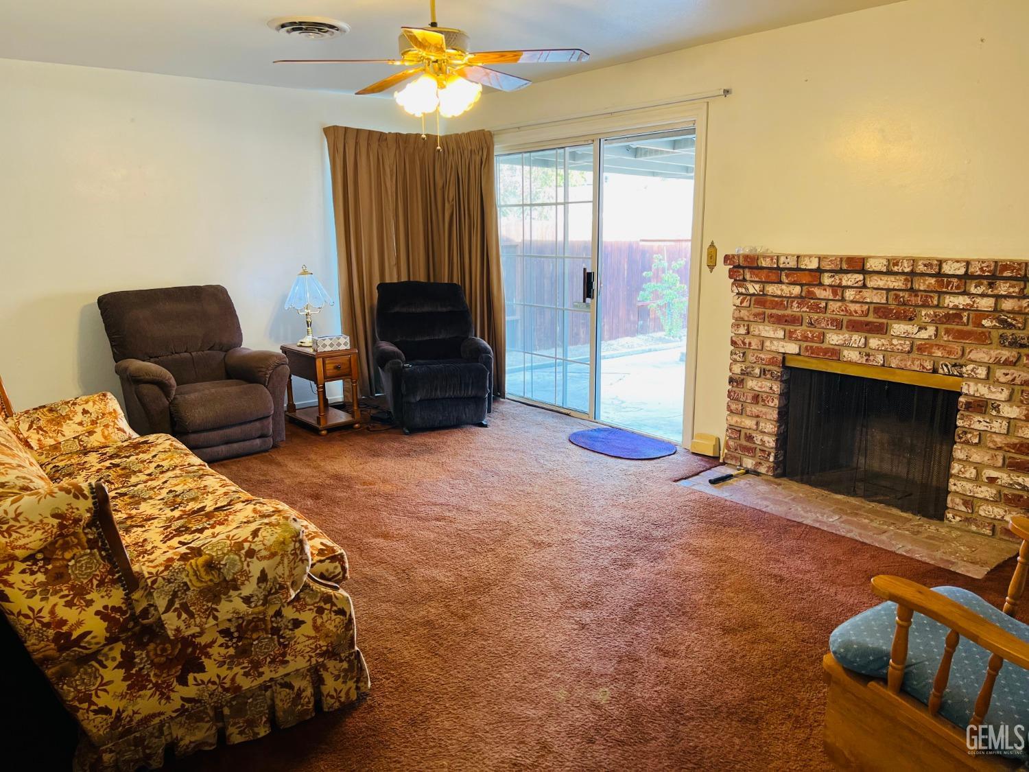 Undisclosed Address Bakersfield, CA 93305 - Photo 3 of 22 a living room with furniture a fireplace and a flat screen tv
