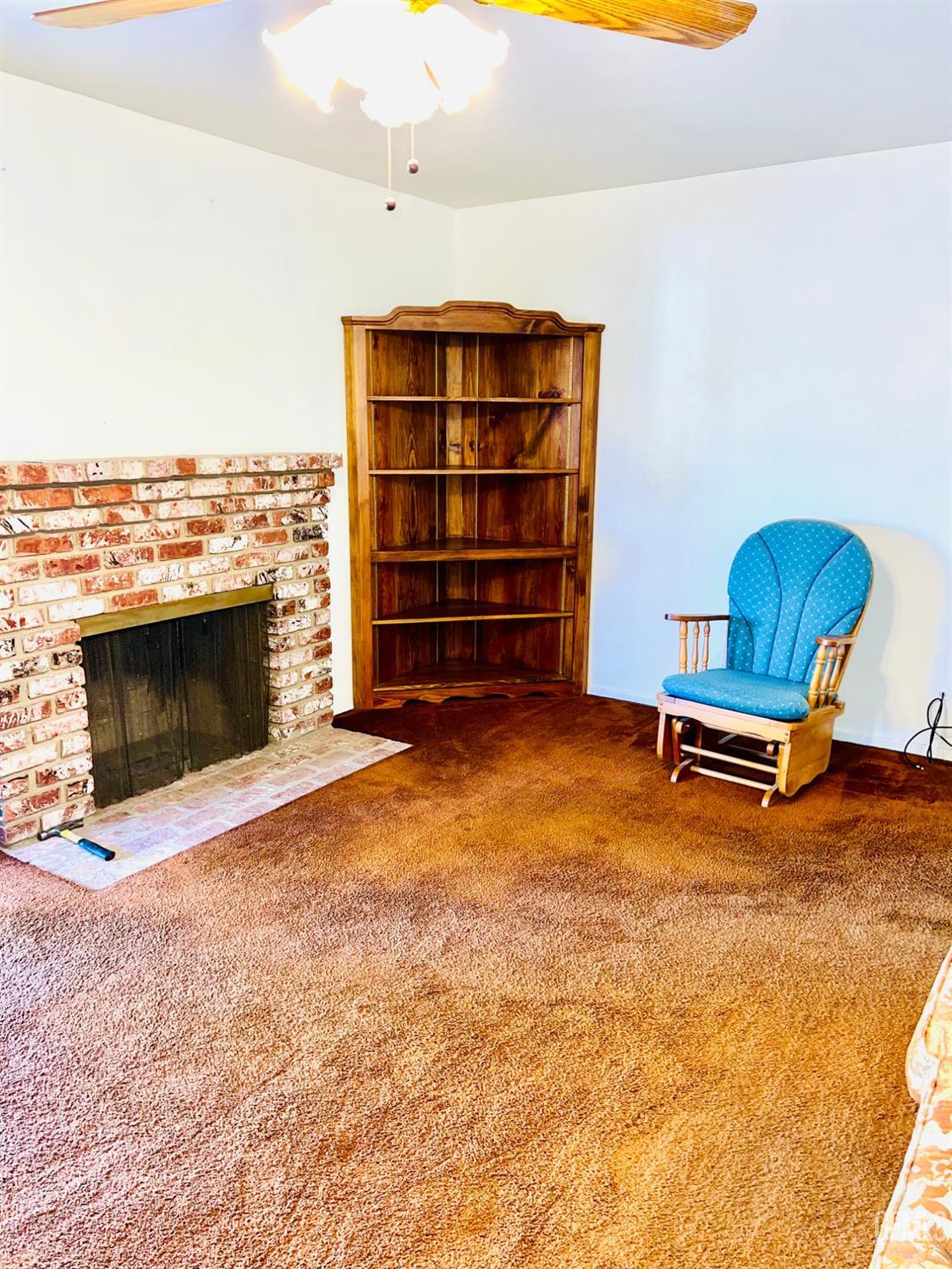 Undisclosed Address Bakersfield, CA 93305 - Photo 5 of 22 a living room with furniture pool and fireplace