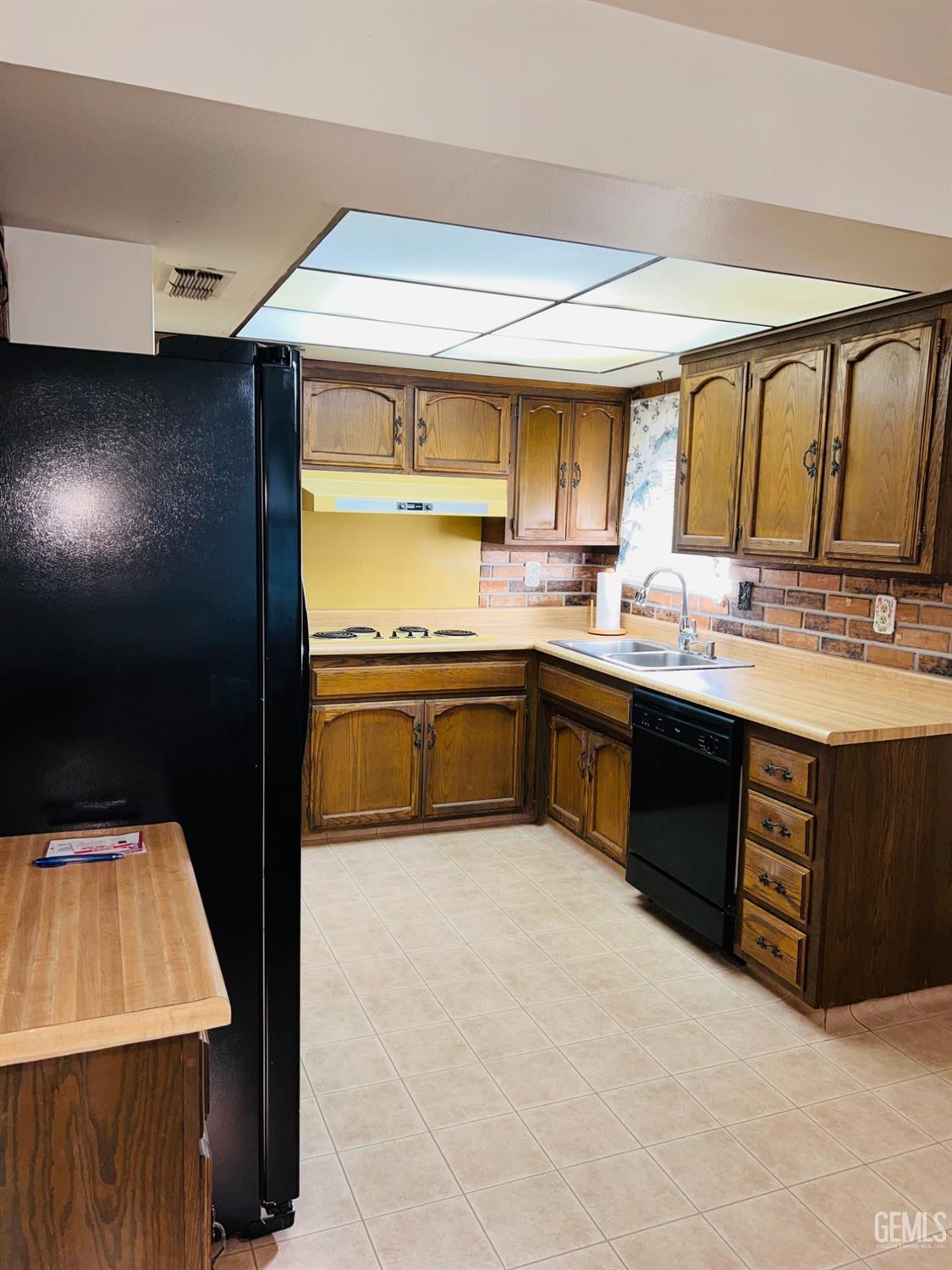 Undisclosed Address Bakersfield, CA 93305 - Photo 8 of 22 a kitchen with stainless steel appliances granite countertop a sink a stove and a refrigerator