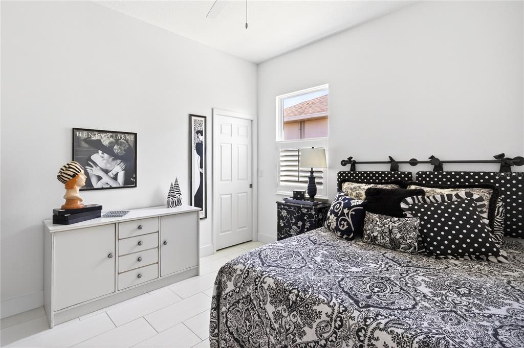 2440 Pawtucket Pass Mount Dora, FL 32757 - Photo 34 of 64 a bedroom with a bed and a chandelier