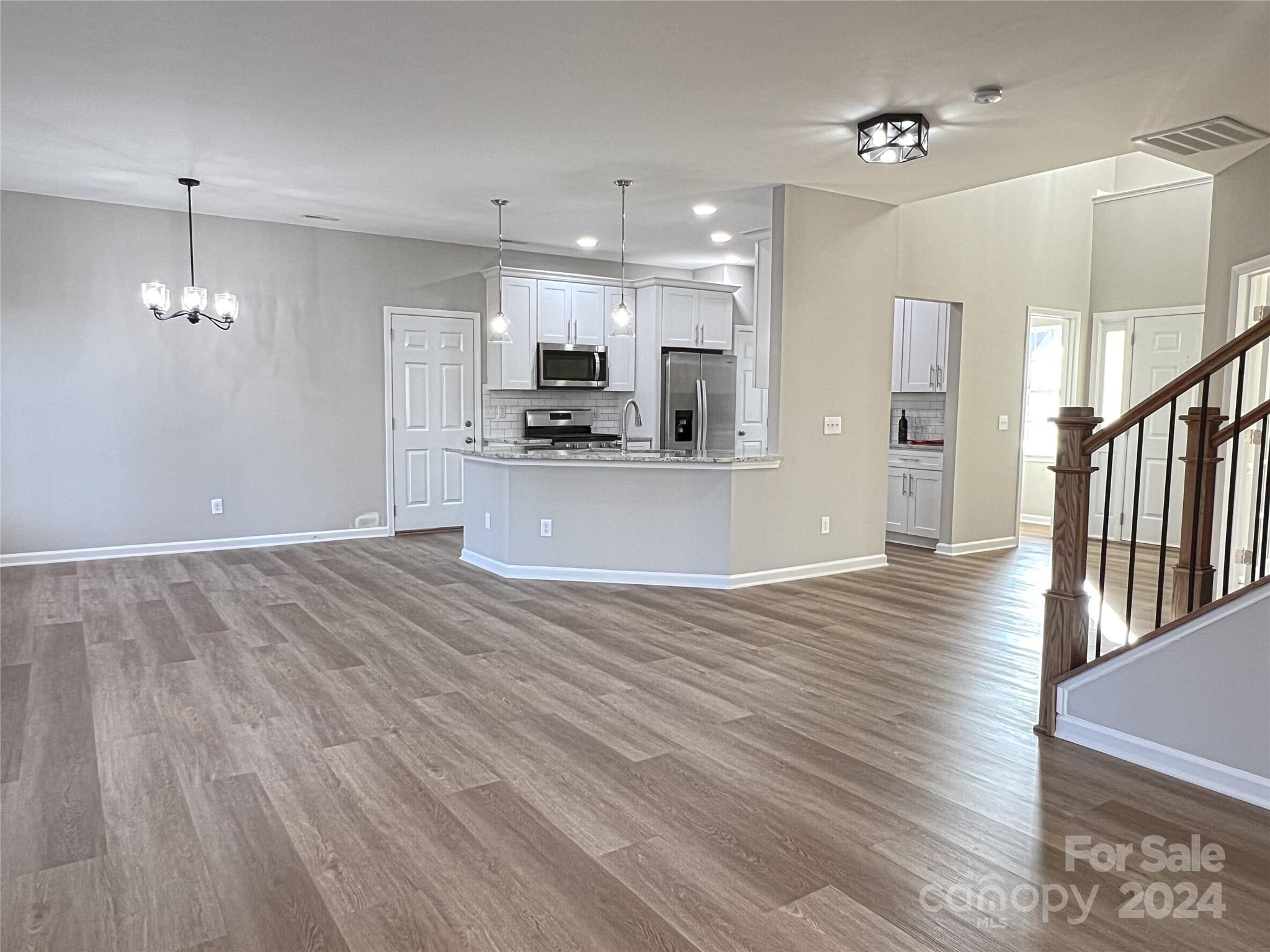 1644 Heather Glen Road Kannapolis, NC 28081 - Photo 11 of 25 a view of a kitchen with a sink a refrigerator and a fireplace