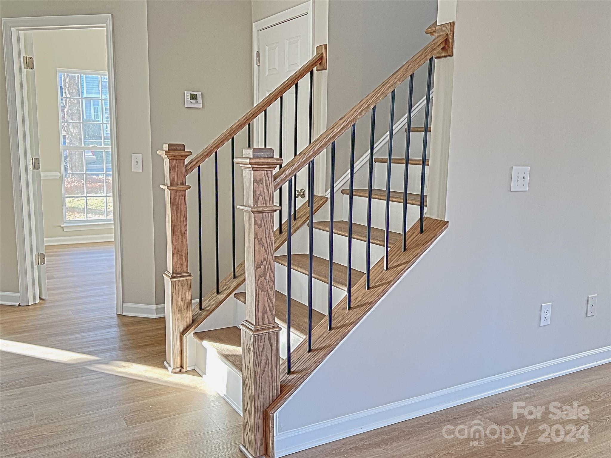 1644 Heather Glen Road Kannapolis, NC 28081 - Photo 12 of 25 a view of staircase with wooden floor and white walls