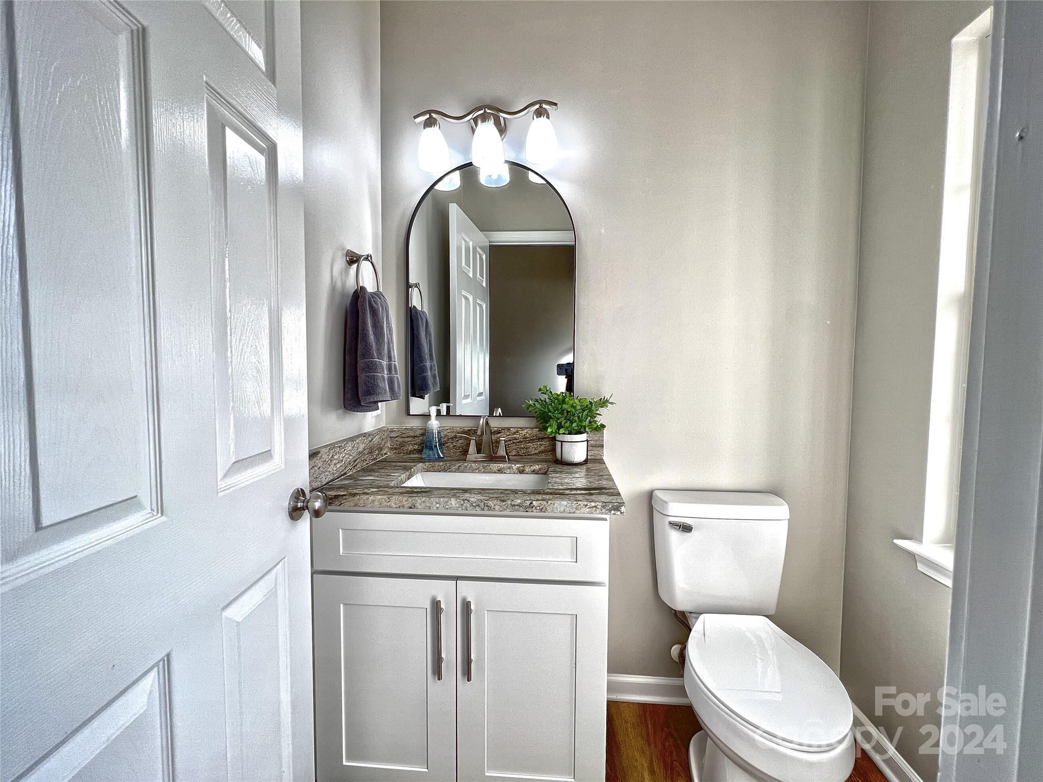 1644 Heather Glen Road Kannapolis, NC 28081 - Photo 14 of 25 a bathroom with a toilet sink and mirror
