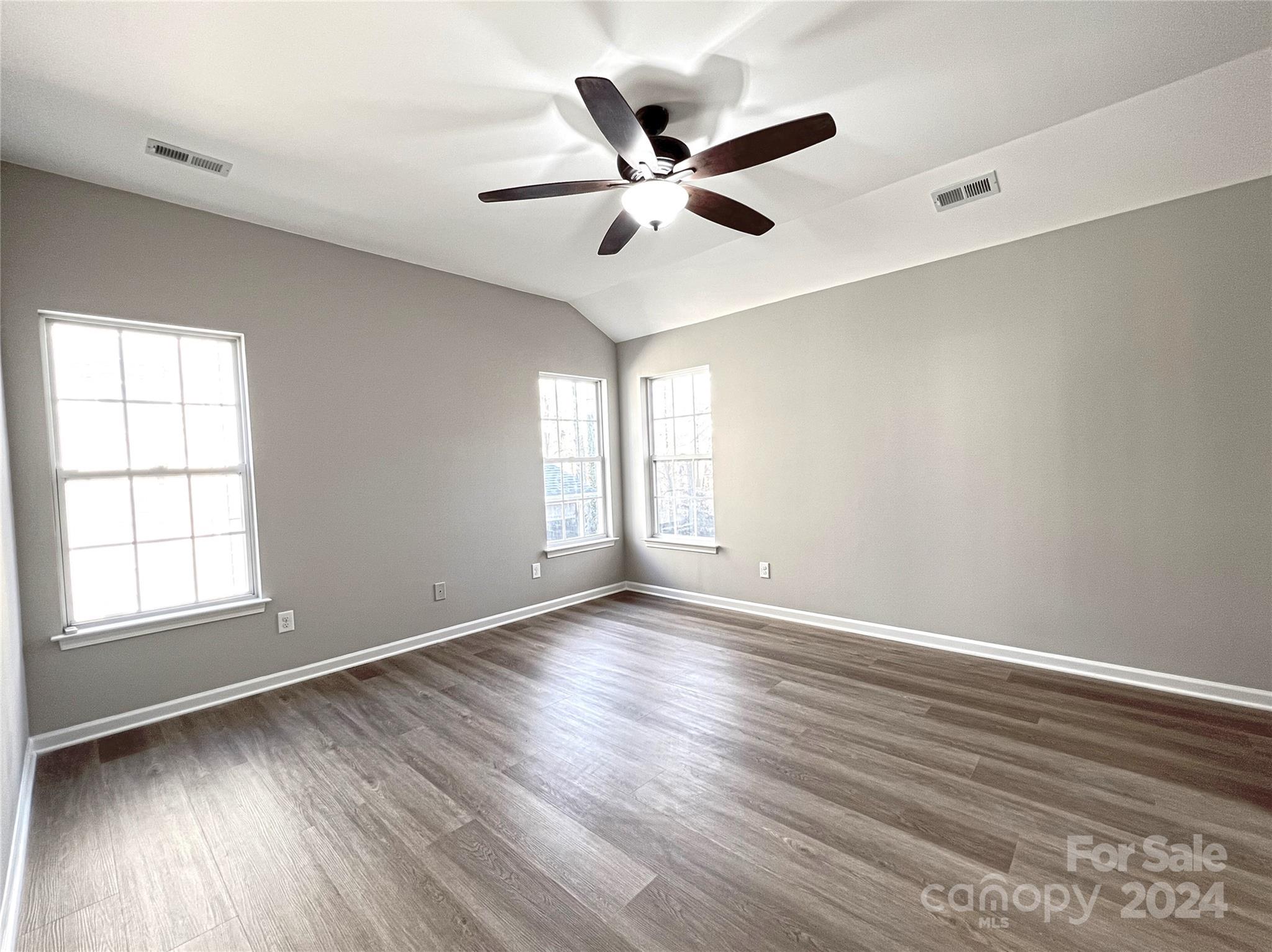 1644 Heather Glen Road Kannapolis, NC 28081 - Photo 16 of 25 an empty room with wooden floor fan and windows