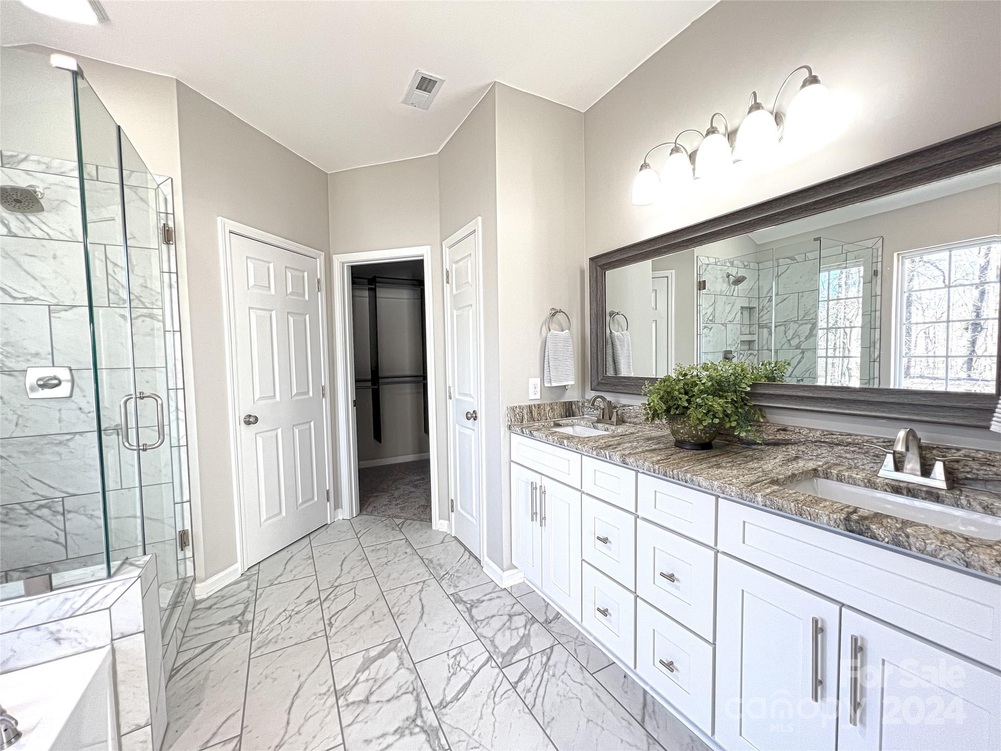 1644 Heather Glen Road Kannapolis, NC 28081 - Photo 17 of 25 a spacious bathroom with a double vanity sink and a mirror