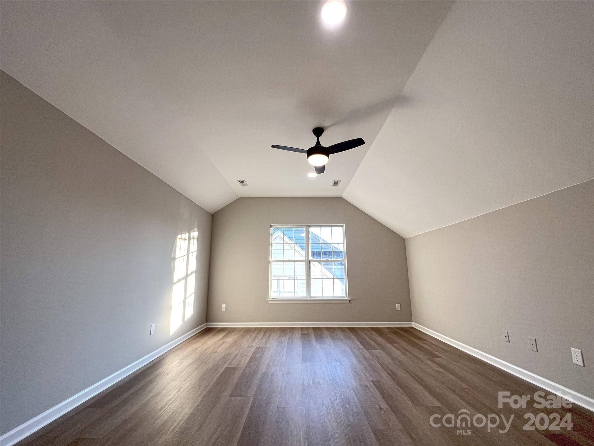 1644 Heather Glen Road Kannapolis, NC 28081 - Photo 21 of 25 an empty room with wooden floor and windows