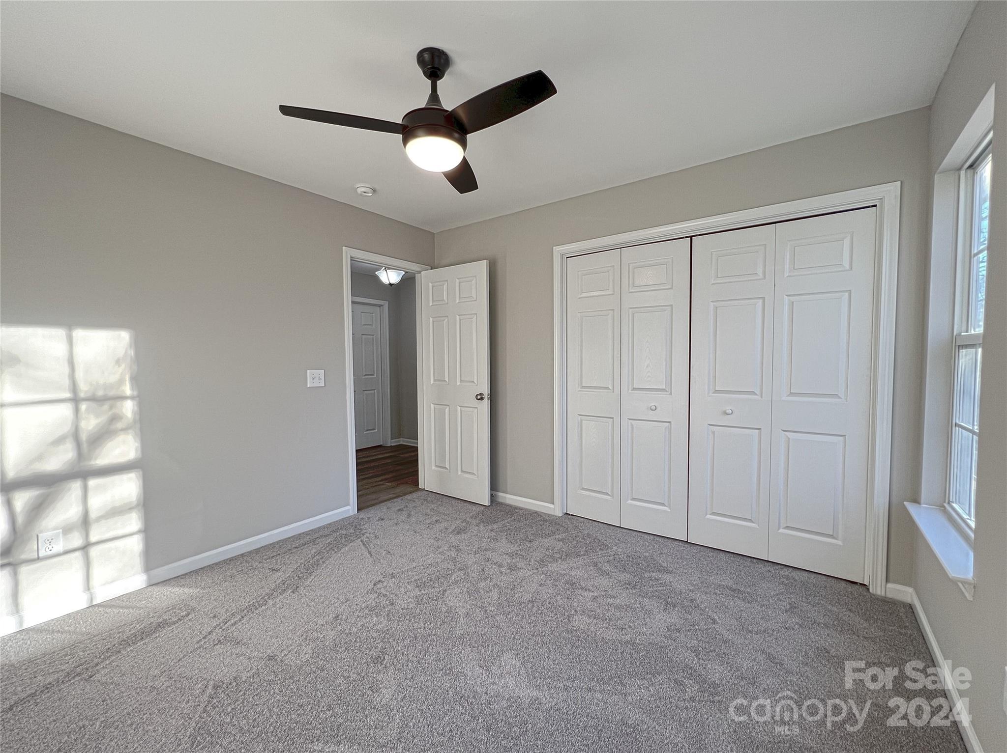1644 Heather Glen Road Kannapolis, NC 28081 - Photo 22 of 25 an empty room with windows and ceiling fan