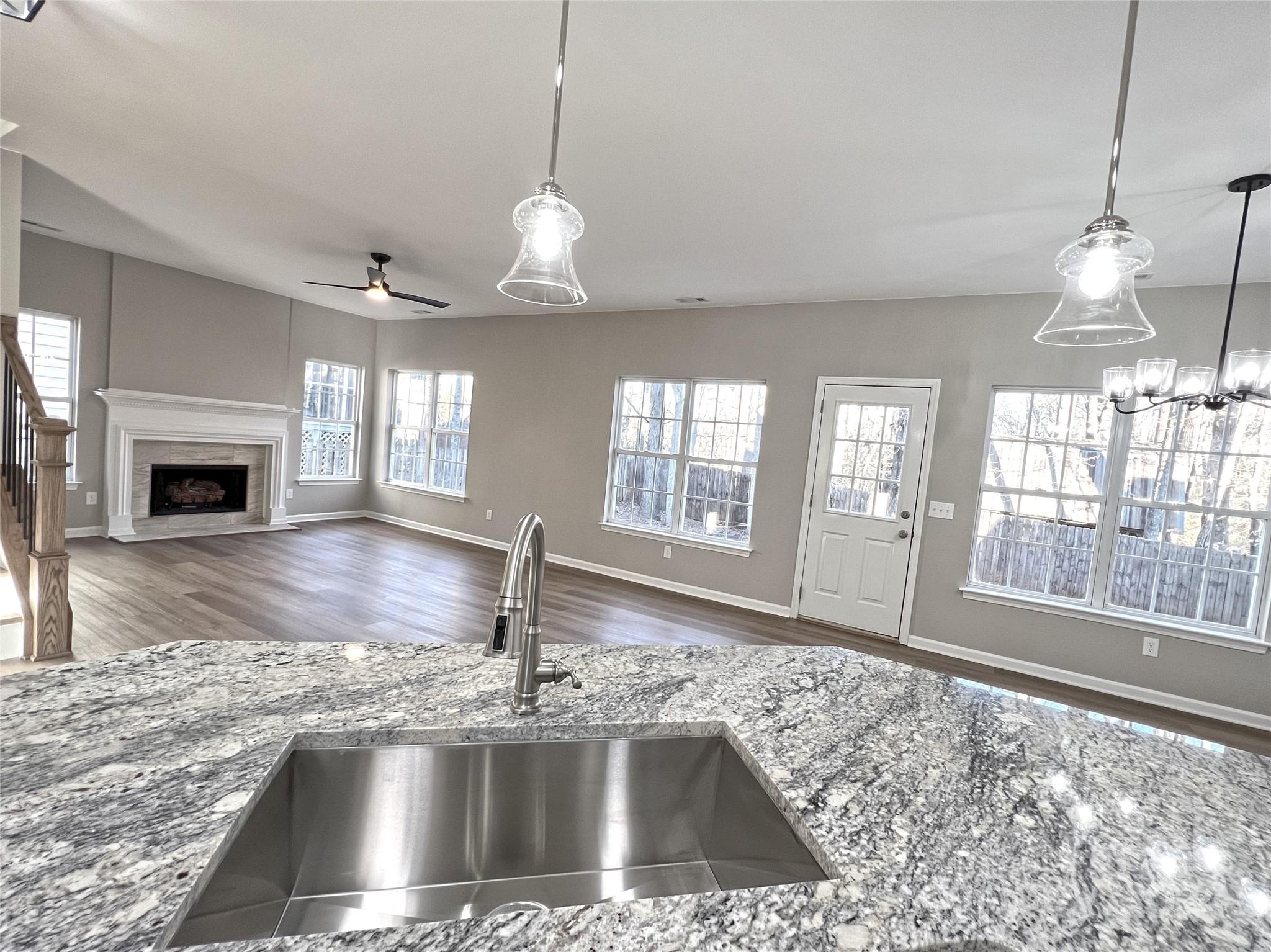 1644 Heather Glen Road Kannapolis, NC 28081 - Photo 5 of 25 a view of a kitchen with a sink wooden floor and a fireplace