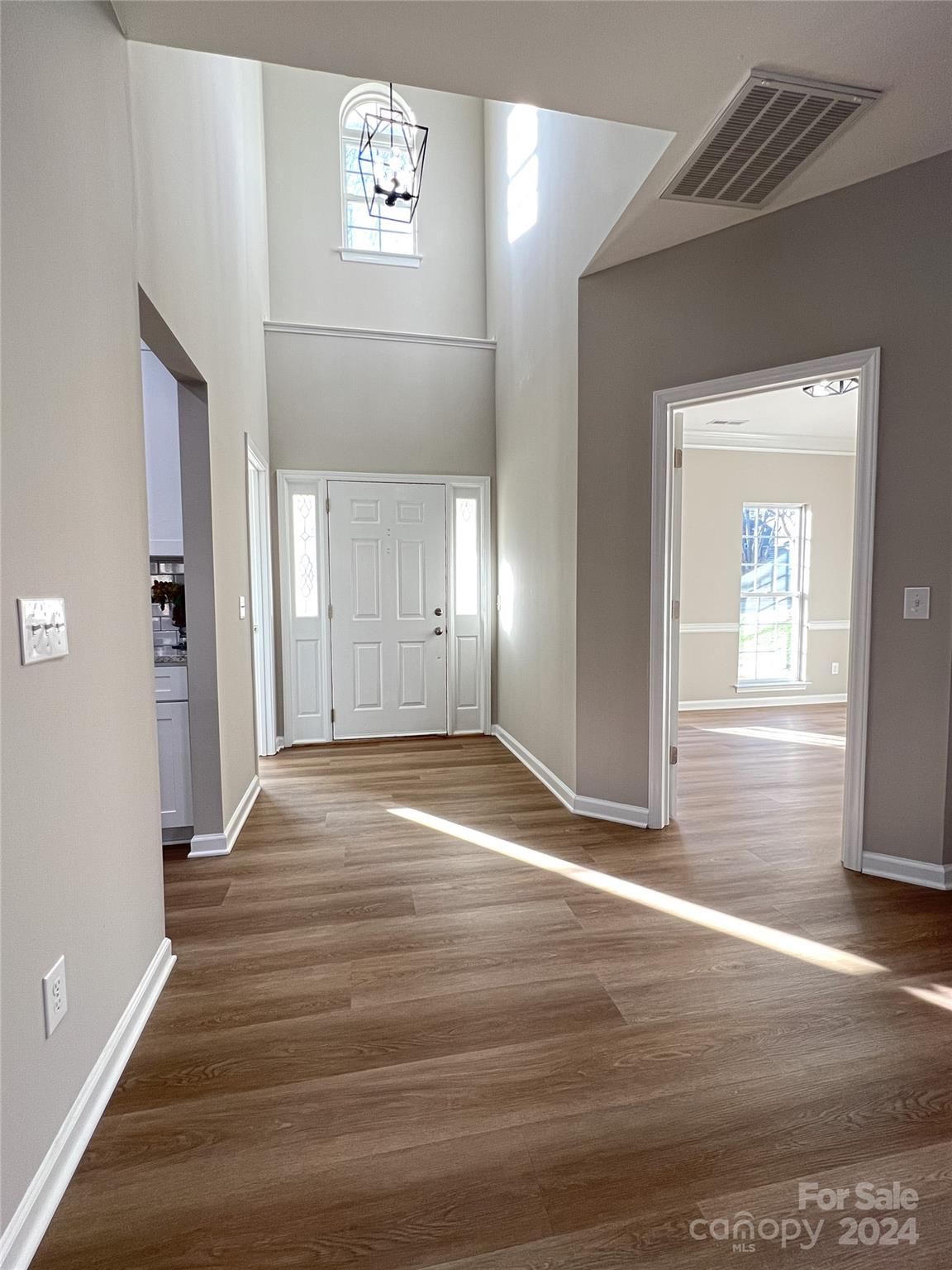 1644 Heather Glen Road Kannapolis, NC 28081 - Photo 6 of 25 an empty room with wooden floor and windows