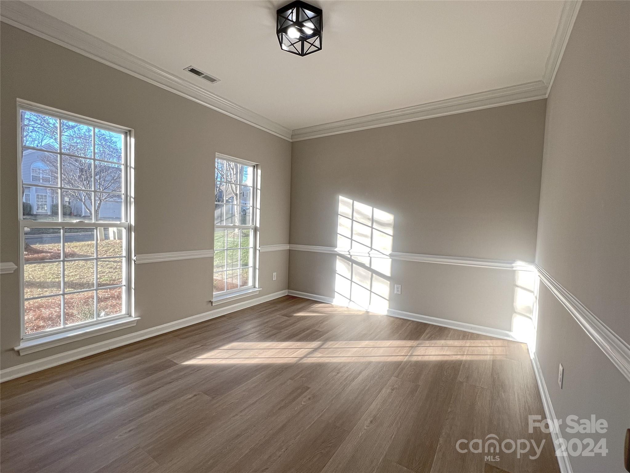 1644 Heather Glen Road Kannapolis, NC 28081 - Photo 7 of 25 a view of an empty room with wooden floor and a window