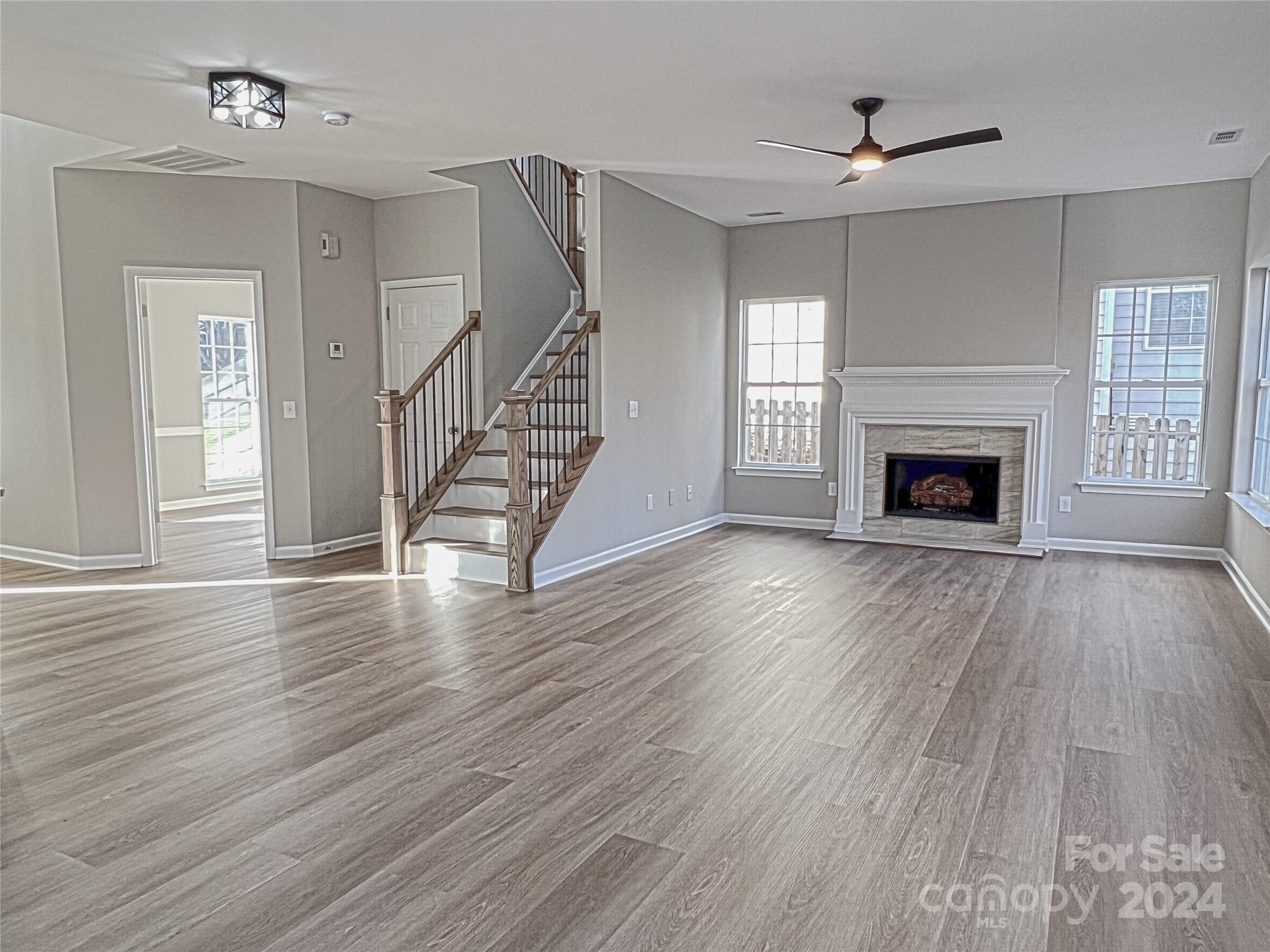 1644 Heather Glen Road Kannapolis, NC 28081 - Photo 10 of 25 wooden floor fireplace and windows in an empty room