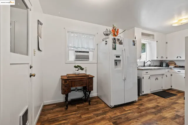 a kitchen with stainless steel appliances a refrigerator and a stove top oven