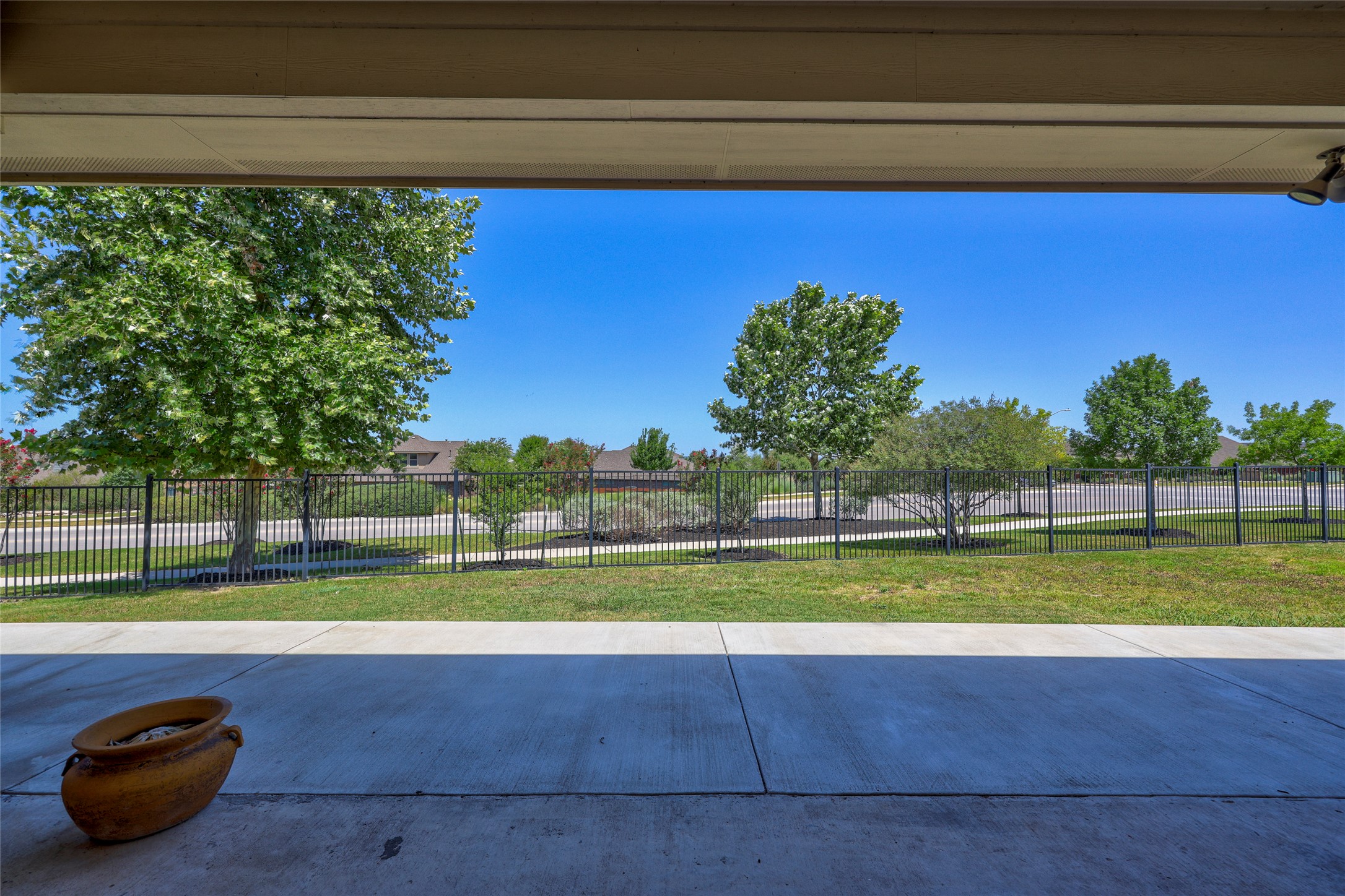 409 Betony Loop Buda, TX 78610 - Photo 29 of 38 A spacious covered patio overlooks a landscaped backyard with a secure fence.