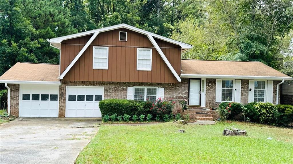 4725 Mercer Road Stone Mountain, GA 30083 - Photo 1 of 1 a front view of a house with a yard